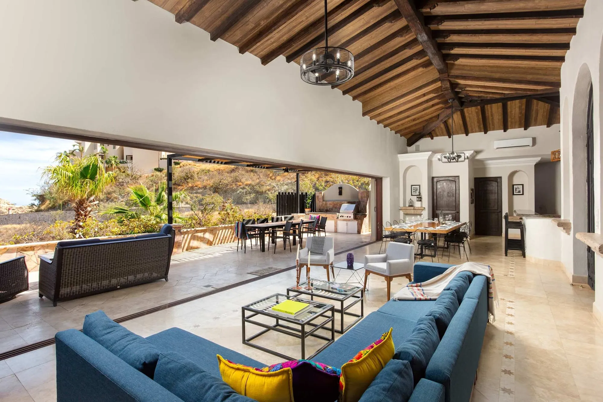 The living room opening onto the terrace through a folding glass wall
