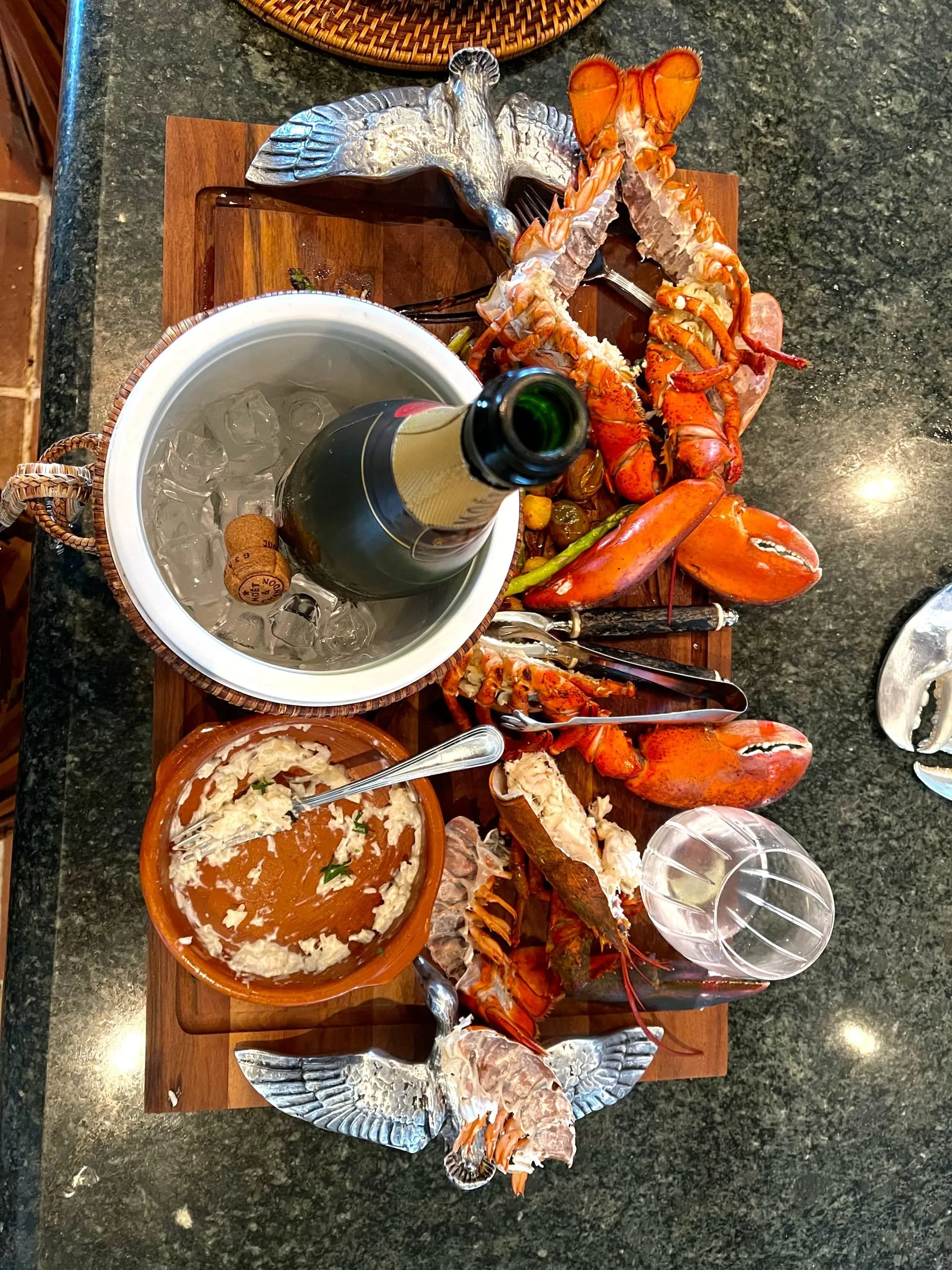 A seafood board of lobster and shrimp on ice, served with champagne