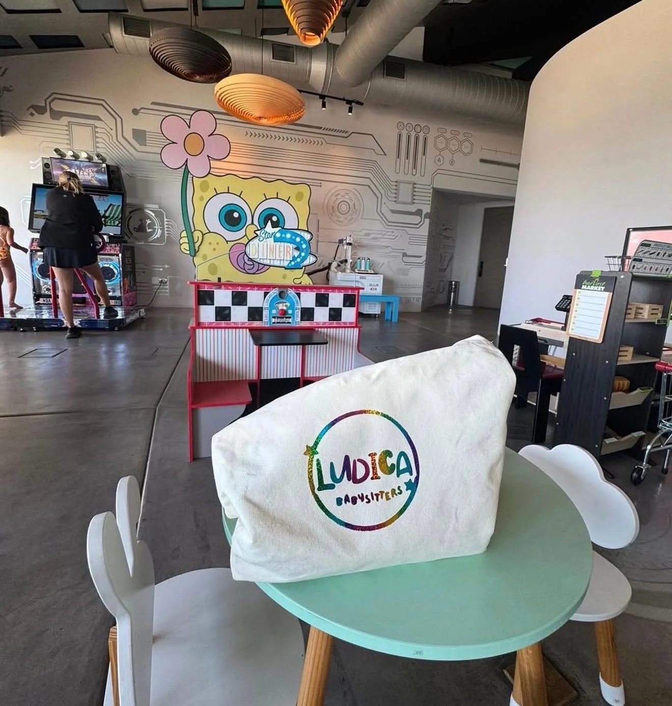 A hotel kids' club set up for the day, a Lúdica bag over one of the little chairs