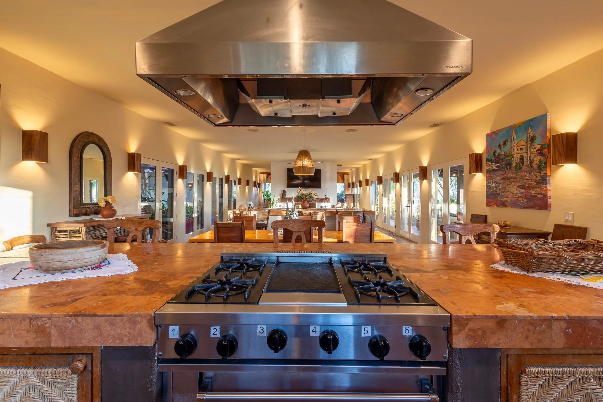 The main kitchen, with a full range under an extractor and copper counters